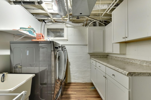 5117 Western Ave, Omaha, NE 68132 - laundry room with cabinet space, washing machine and dryer, dark wood-style floors, and concrete block wall