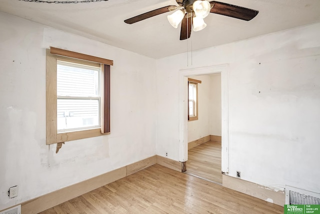 unfurnished room with visible vents, a ceiling fan, and light wood finished floors