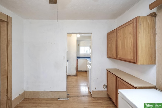 interior space featuring laundry area, light wood-style flooring, and washer and dryer