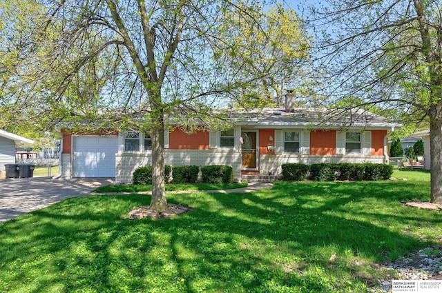 ranch-style home with brick siding, a garage, driveway, and a front yard