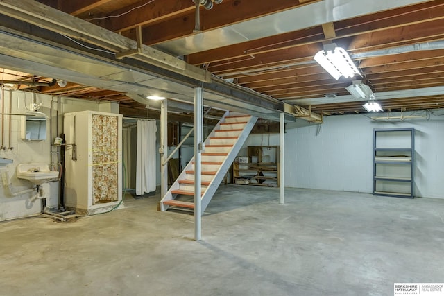 unfinished below grade area with a sink and stairs