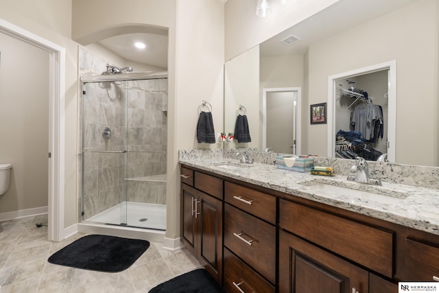 full bath featuring visible vents, a sink, and a shower stall