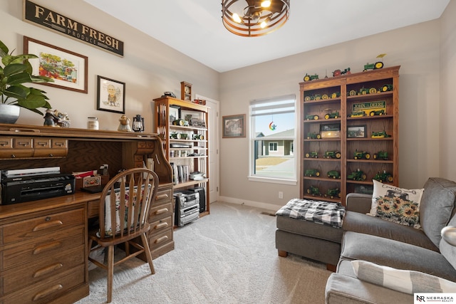office area with baseboards, a notable chandelier, and light carpet