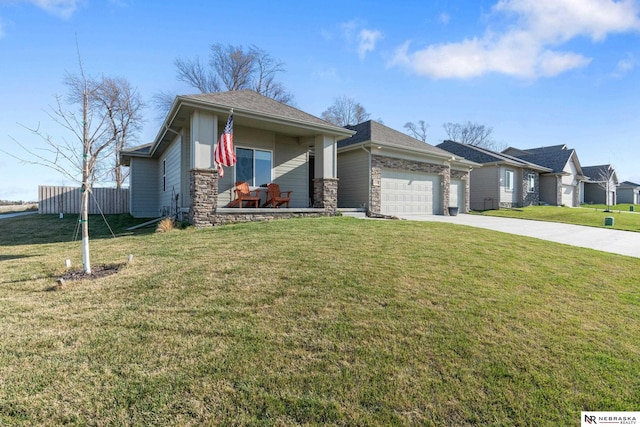 view of front of house with covered porch, a front lawn, concrete driveway, an attached garage, and stone siding