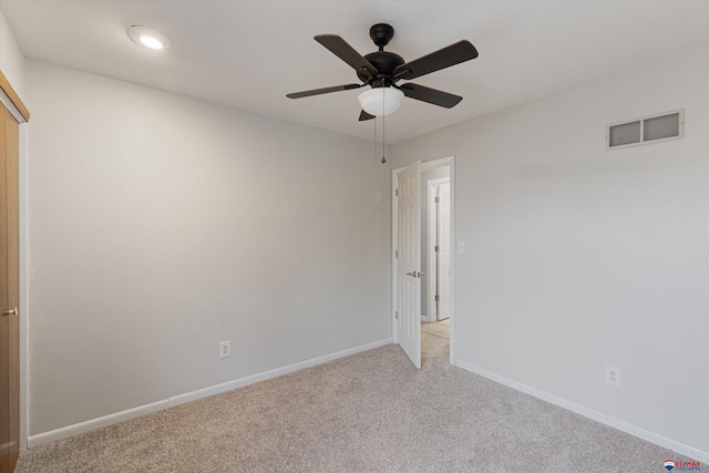unfurnished room with light colored carpet, a ceiling fan, baseboards, recessed lighting, and visible vents