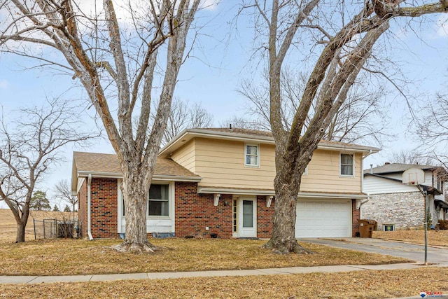 view of front of house featuring brick siding, aphalt driveway, fence, and a garage