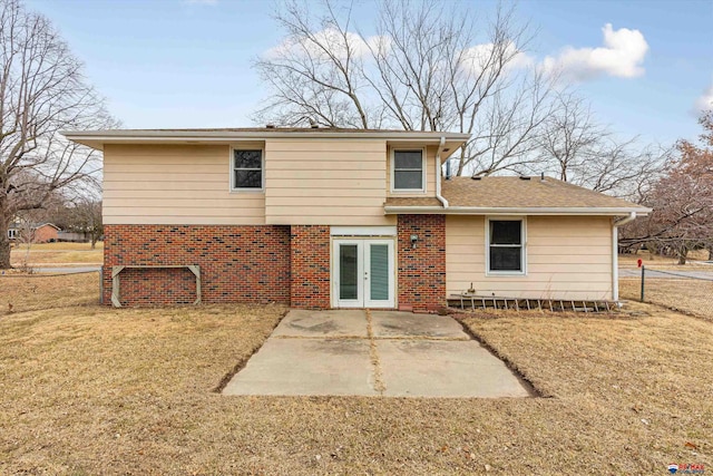 back of house with a yard, a patio, french doors, and brick siding