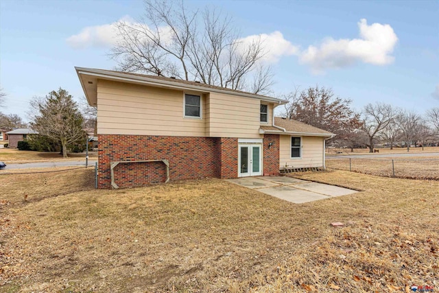 back of property featuring a yard, a patio, fence, and french doors