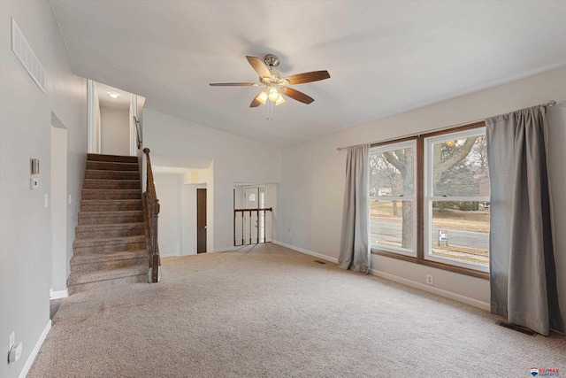 unfurnished living room featuring ceiling fan, vaulted ceiling, light carpet, and visible vents