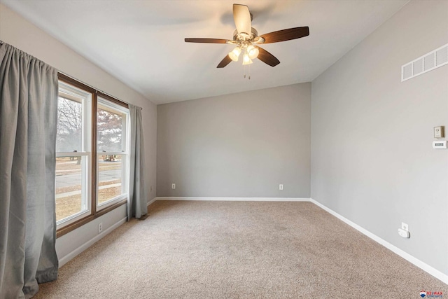 unfurnished room with baseboards, light carpet, and visible vents