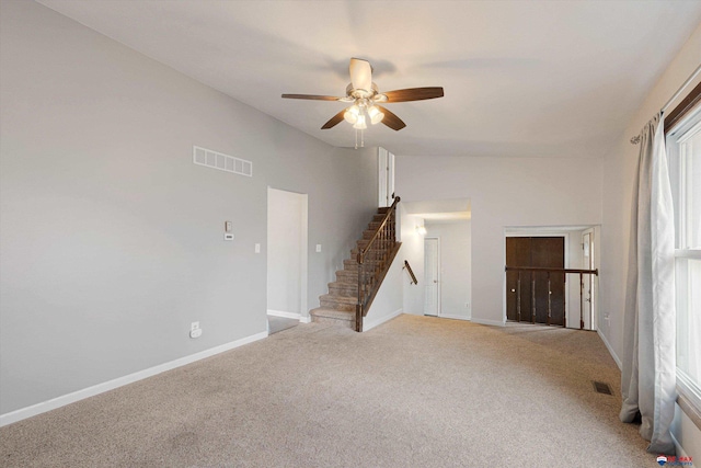 unfurnished living room featuring baseboards, light carpet, a ceiling fan, and visible vents
