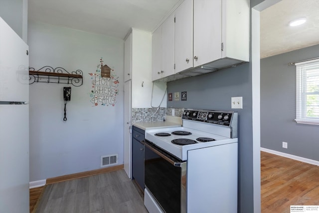 kitchen featuring visible vents, light wood-style flooring, white appliances, and white cabinetry