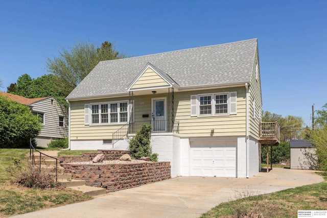 view of front of home with driveway, a shingled roof, and a garage