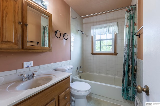bathroom featuring vanity, shower / tub combo with curtain, toilet, and tile walls
