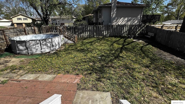 view of yard featuring a fenced in pool and a fenced backyard