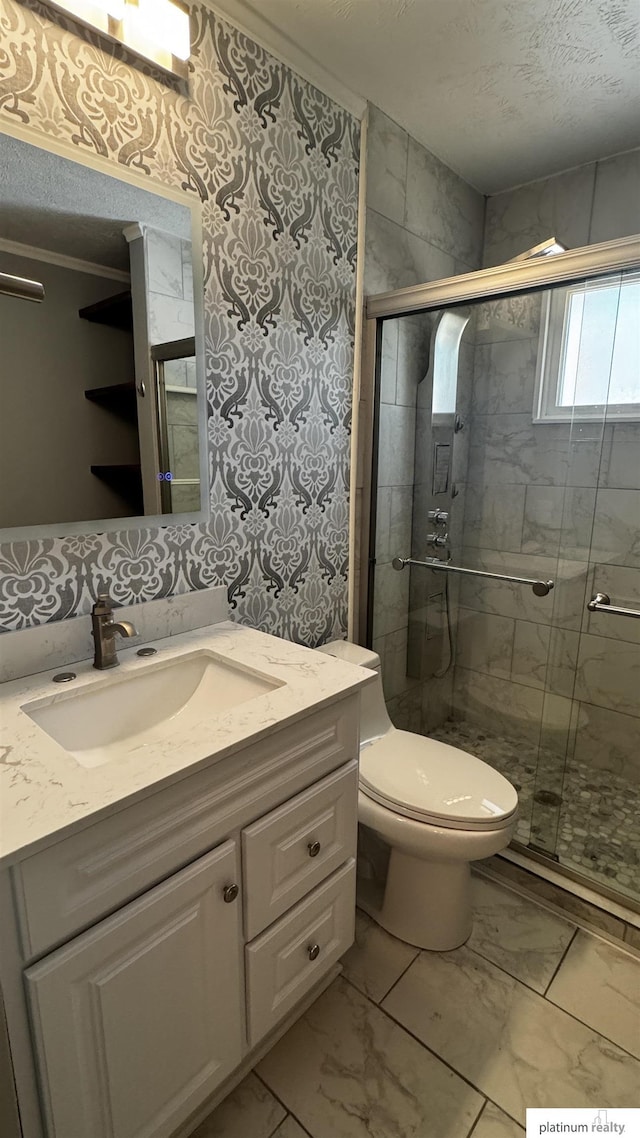 bathroom with toilet, a shower stall, and marble finish floor