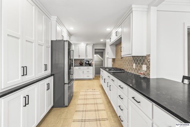 kitchen featuring recessed lighting, white cabinets, tasteful backsplash, light tile patterned floors, and stainless steel appliances
