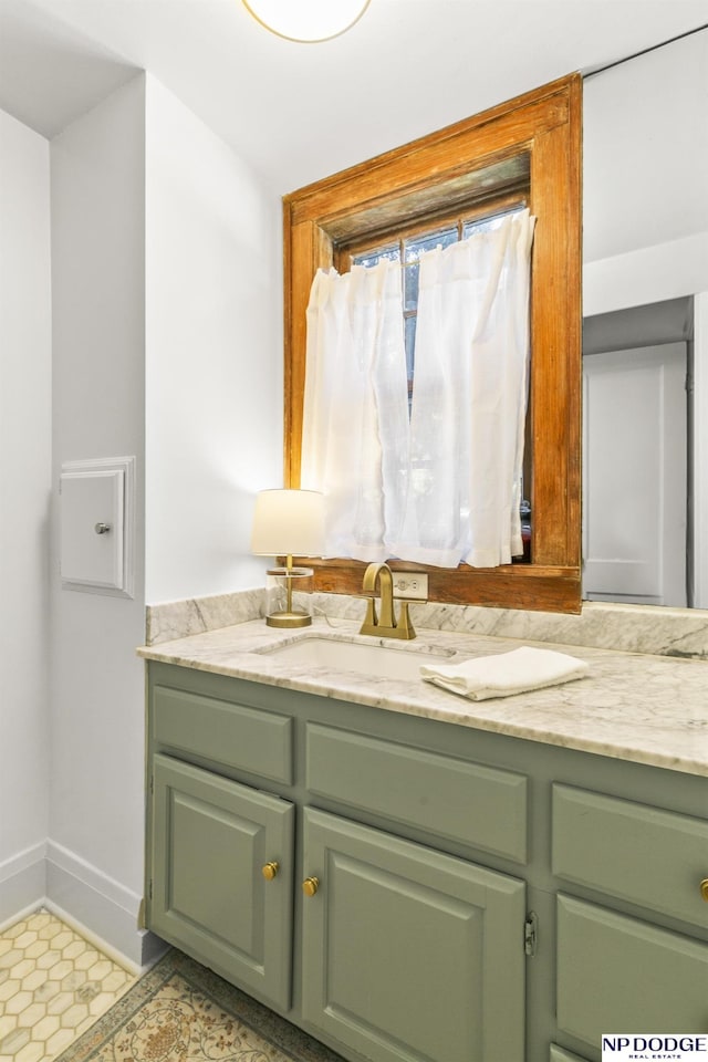 bathroom with vanity and baseboards