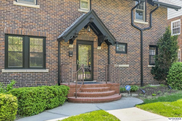 property entrance featuring brick siding