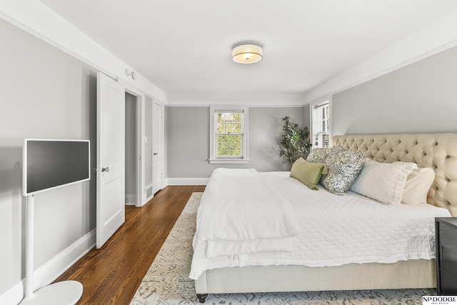 bedroom with baseboards, dark wood finished floors, and visible vents