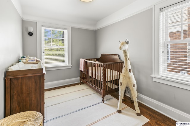 bedroom featuring baseboards and wood finished floors