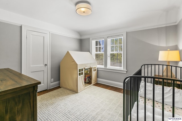 bedroom featuring baseboards and wood finished floors