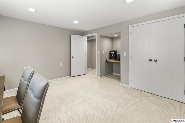unfurnished office featuring baseboards, light carpet, and recessed lighting
