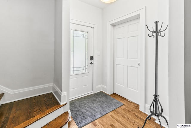 entrance foyer with baseboards and wood finished floors