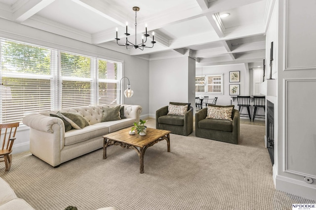 carpeted living room with a healthy amount of sunlight, beamed ceiling, baseboards, coffered ceiling, and a notable chandelier