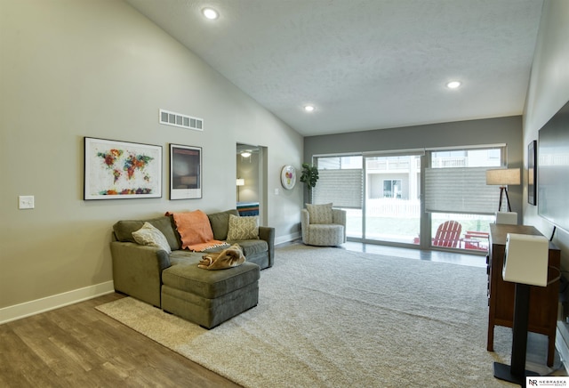 living room with baseboards, recessed lighting, wood finished floors, and visible vents