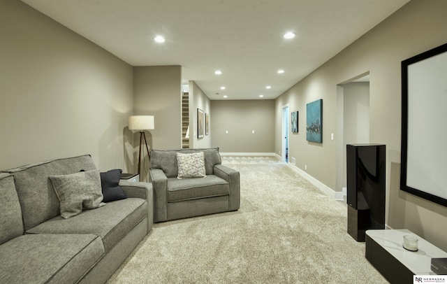 living area with recessed lighting, baseboards, light carpet, and stairway