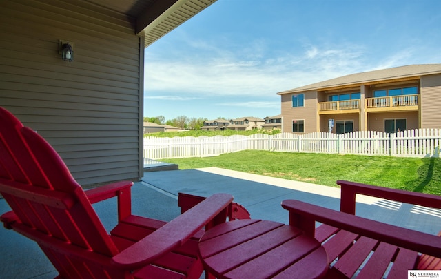 view of patio with fence and a residential view