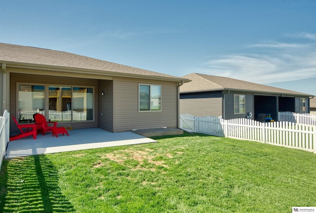 back of property with fence, a patio, and a yard
