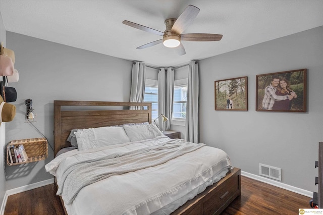 bedroom with baseboards, a ceiling fan, dark wood-type flooring, and visible vents