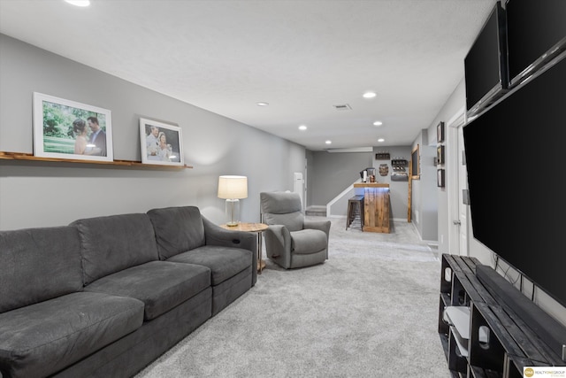 carpeted living area featuring recessed lighting and baseboards