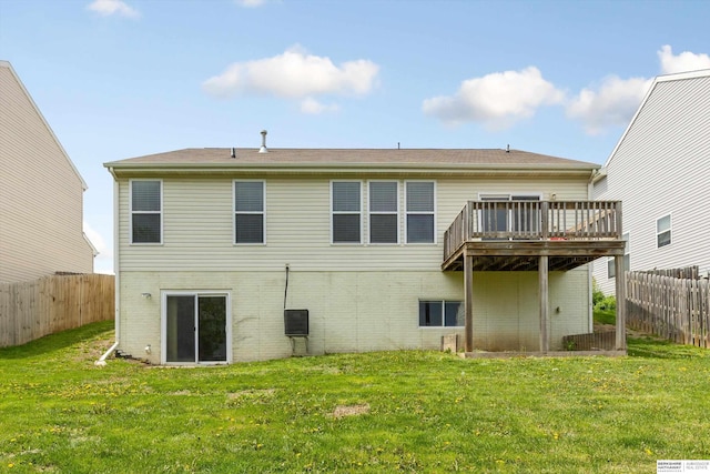 back of property with brick siding, fence, and a deck