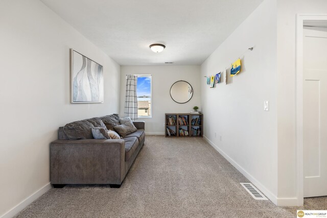 carpeted living room featuring baseboards and visible vents