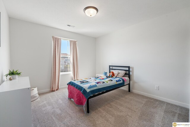 carpeted bedroom with baseboards and visible vents