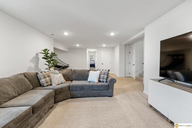 living area with stairway, baseboards, light carpet, and recessed lighting