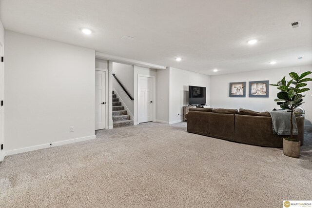 carpeted living area with recessed lighting, stairs, baseboards, and visible vents