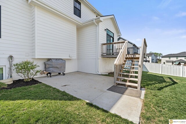 exterior space with a wooden deck, fence, and stairway