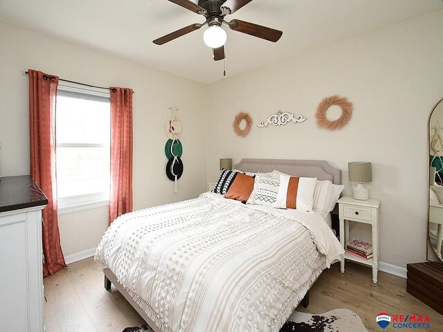 bedroom featuring baseboards, ceiling fan, and wood finished floors