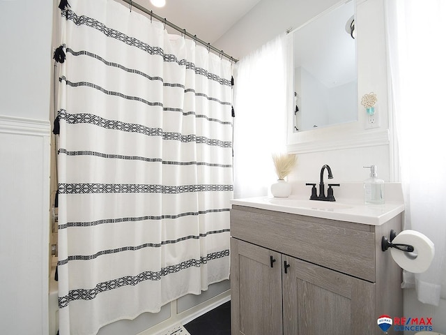 full bath featuring vanity and shower / bathtub combination with curtain