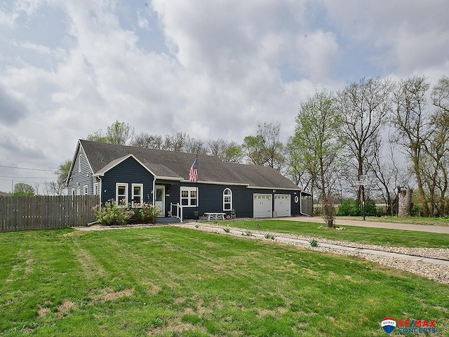 ranch-style home featuring fence, an attached garage, concrete driveway, and a front lawn