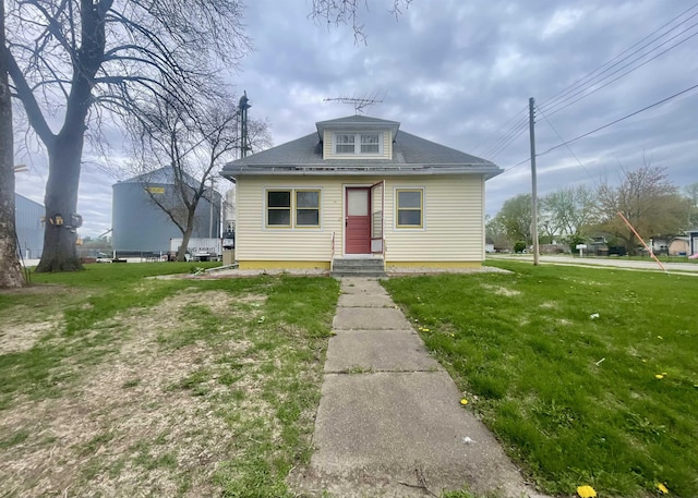 bungalow-style house with a front yard