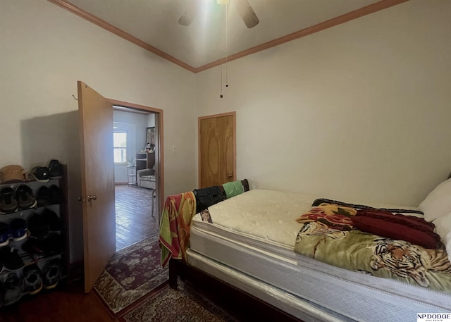 bedroom with crown molding, ceiling fan, and wood finished floors