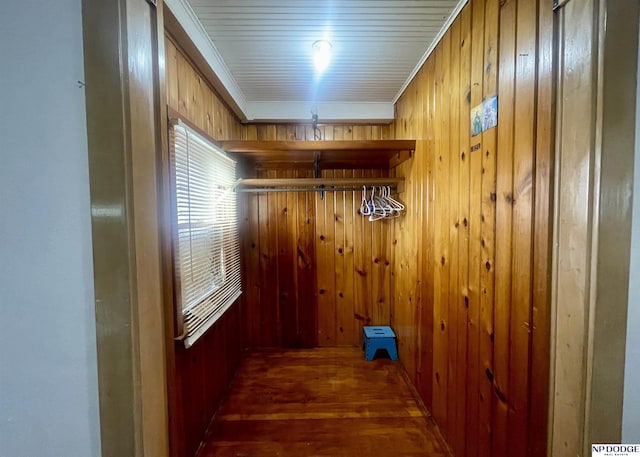laundry area featuring wood walls and ornamental molding