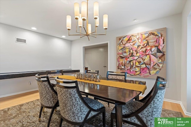 dining room featuring an inviting chandelier, recessed lighting, light wood-type flooring, and visible vents
