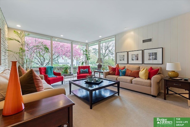living room with carpet floors, expansive windows, and visible vents