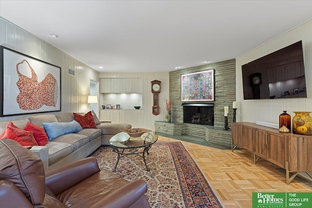 living area featuring a decorative wall and a fireplace